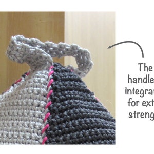 May include: Gray and black crocheted doorstop with a pink trim and a gray handle. The handle is integrated into the doorstop for extra strength.