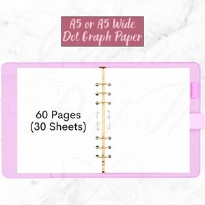 May include: A pink A5 wide dot grid notebook with 60 pages (30 sheets) and a gold coil binding. The notebook is open to show the dot grid paper.