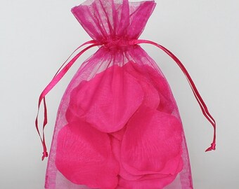 May include: A pink tulle bag filled with pink rose petals. The bag has a drawstring closure and is perfect for weddings, parties, or special occasions.