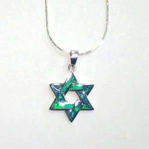May include: A silver chain necklace with a green opal Star of David pendant.