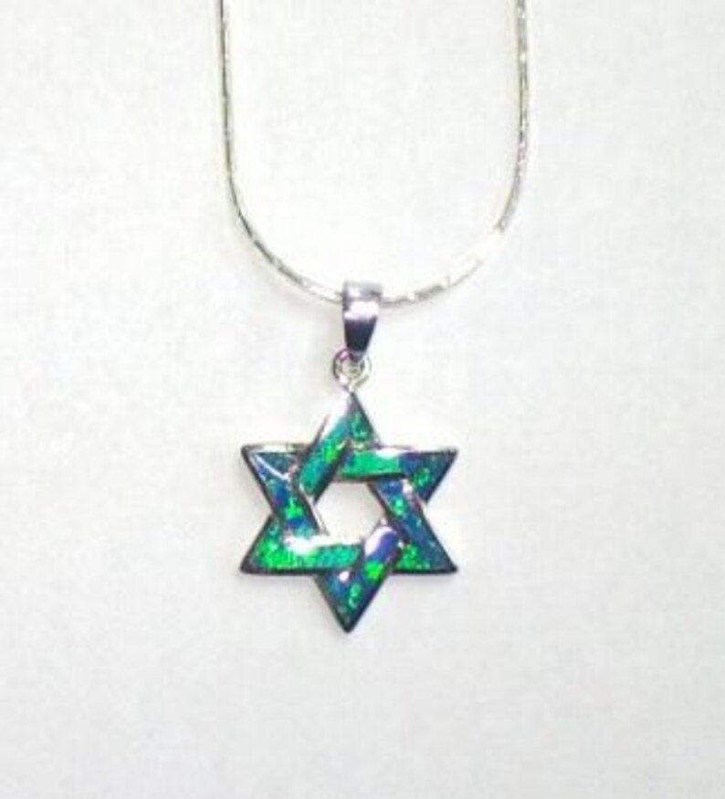 May include: A silver chain necklace with a green opal Star of David pendant.