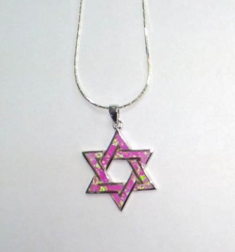 May include: A silver chain necklace with a pink opal Star of David pendant.