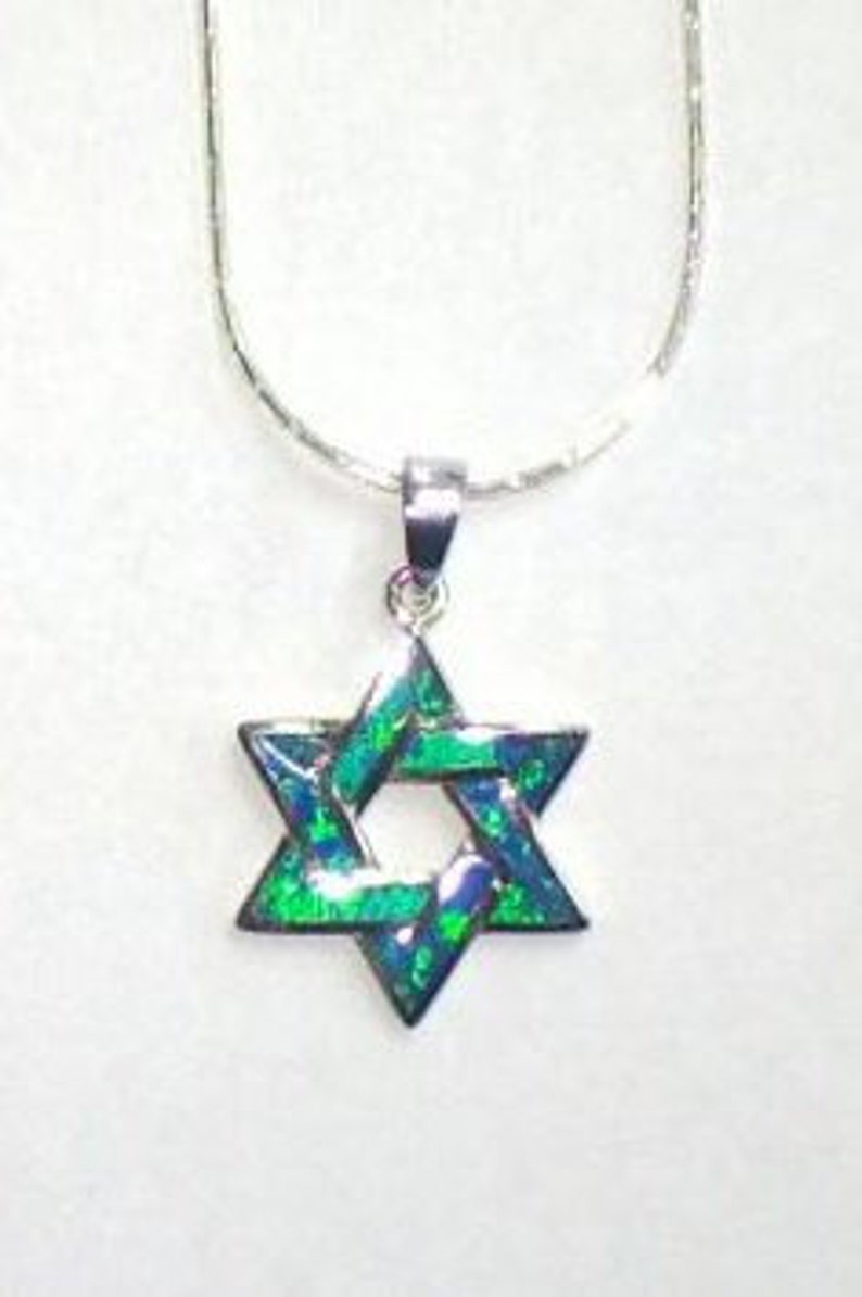 May include: A silver chain necklace with a green and blue opal Star of David pendant.