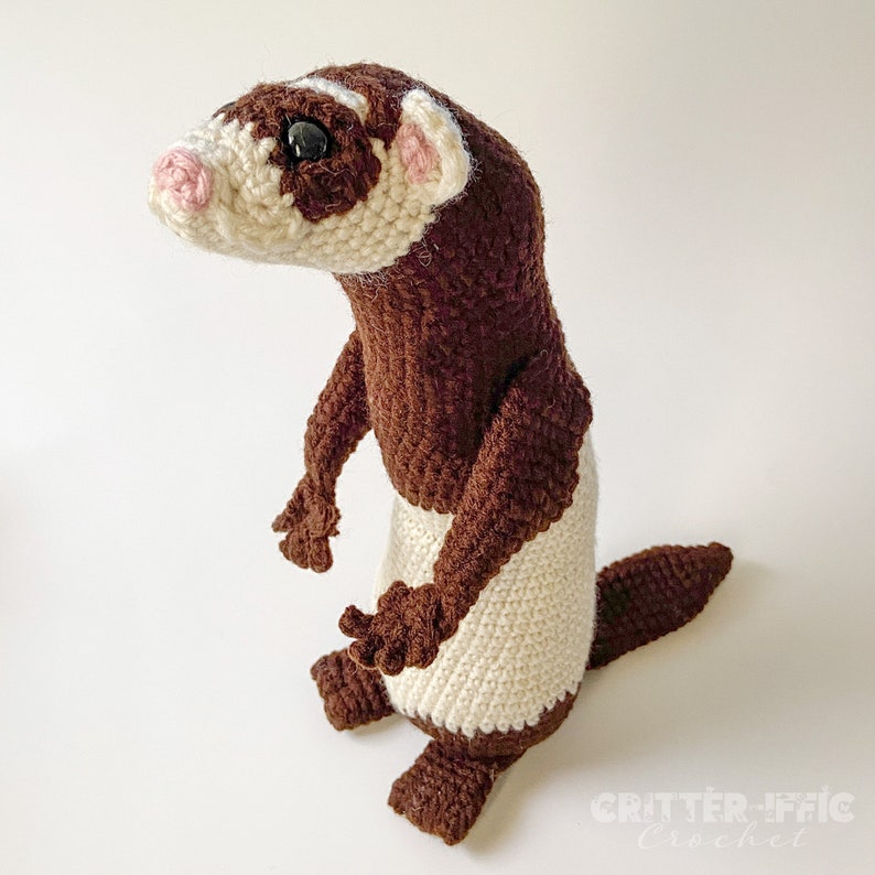 crocheted ferret on a white background looking left