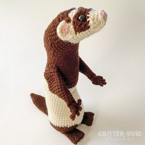 crocheted ferret on a white background looking right