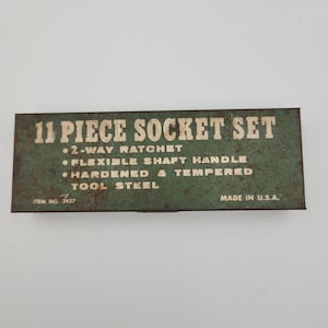 May include: A vintage 11-piece socket set in a rectangular box. The box is green with white lettering that reads "11 Piece Socket Set", "2-Way Ratchet", "Flexible Shaft Handle", "Hardened & Tempered Tool Steel", and "Made in U.S.A."