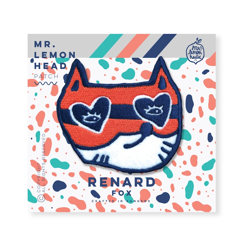 May include: A red and blue embroidered iron-on patch featuring a fox wearing heart-shaped sunglasses. The patch says "Renard Fox" and "Crafted in Bangkok".