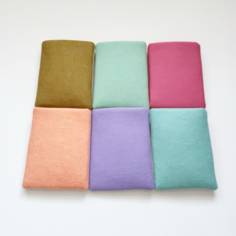 May include: Six rectangular felt squares in various pastel colors: olive green, mint green, hot pink, peach, lavender, and teal. The squares are arranged in a grid pattern, showcasing the range of colors.