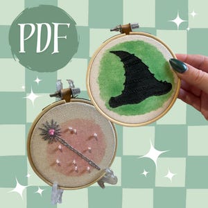 May include: Two embroidery hoops with witchy designs. One features a black witch hat on a green background, the other a pink-toned background with a wand. The word "PDF" is in a green circle in the upper left corner.
