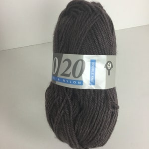 May include: A skein of dark brown yarn labeled "Double Knit Wool & Nylon 020"