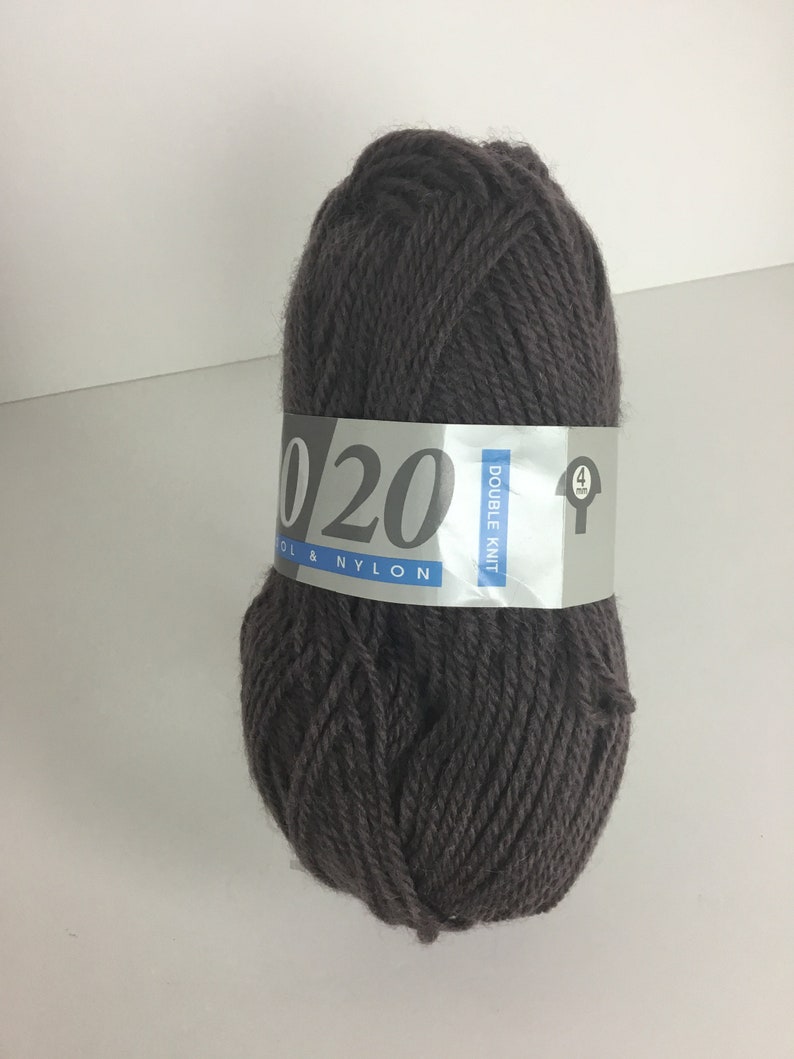 May include: A skein of dark brown yarn labeled "Double Knit Wool & Nylon 020"