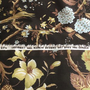 May include: Brown fabric with a floral pattern featuring yellow, white, and brown flowers. The fabric has a white label with the text "Copyright USA, Hardin Designs Vat Dyes Pre-Shrunk".