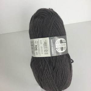 May include: A ball of dark brown yarn with a white label that reads "SIRDAR machine washable 80% WOOL 20% NYLON 50g 110m 035081 044"