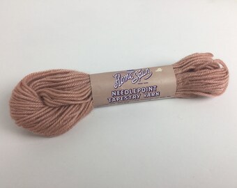 May include: A skein of light pink Home Spun needlepoint tapestry yarn.