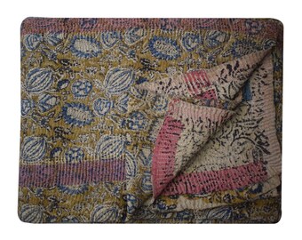 May include: A kantha quilt with a floral pattern in shades of blue, pink, and brown. The quilt is made of recycled saris and is hand-stitched.