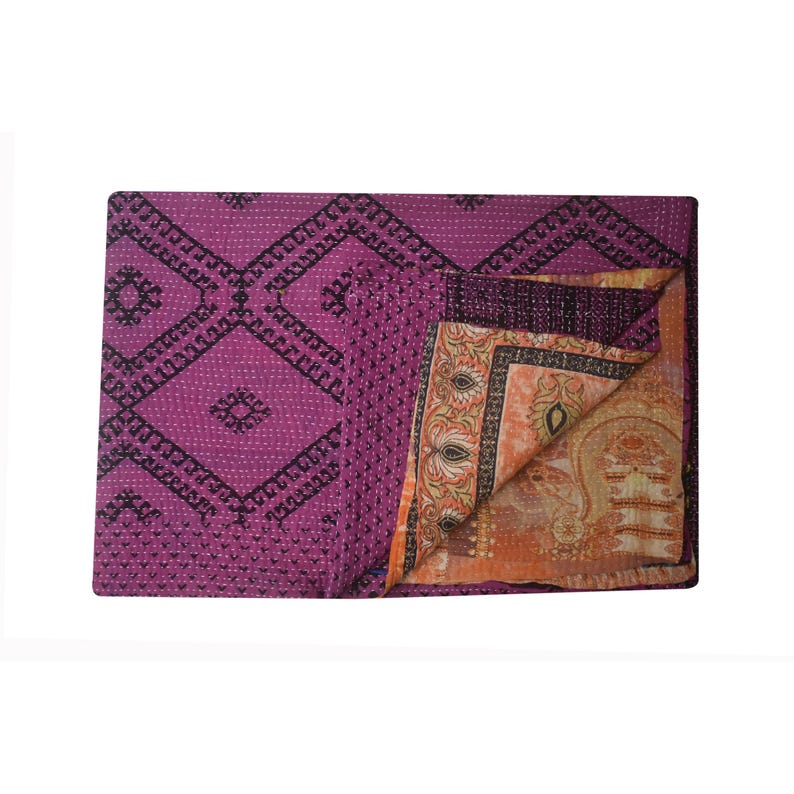May include: A purple kantha quilt with a geometric pattern on one side and a floral pattern on the other side.