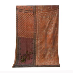 May include: A patchwork quilt with a variety of floral and geometric patterns in shades of orange, brown, and pink.