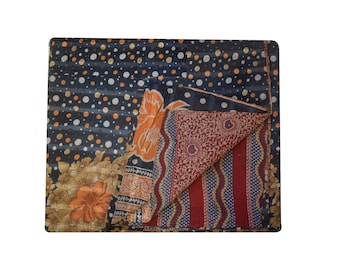 May include: A kantha quilt with a patchwork design featuring a black and white polka dot pattern, a floral pattern, and a red and blue striped pattern.