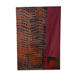 May include: A rectangular fabric wall hanging with a blue and orange tie-dye pattern on the left side and a solid burgundy colour on the right side. The bottom of the hanging features a floral pattern.