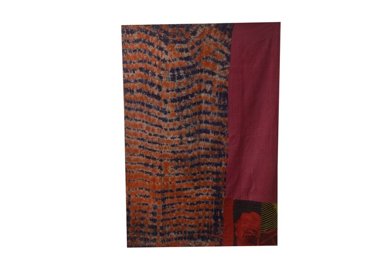 May include: A rectangular fabric wall hanging with a blue and orange tie-dye pattern on the left side and a solid burgundy colour on the right side. The bottom of the hanging features a floral pattern.
