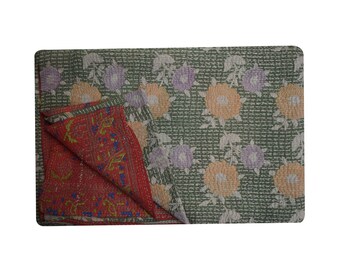 May include: A green and white kantha quilt with a floral pattern. The quilt is folded in half, revealing a red and orange kantha quilt with a geometric pattern.