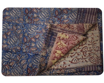 May include: A blue and brown kantha quilt with a floral pattern. The quilt is folded in half and the fabric is soft and textured.