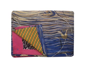 May include: A blue and brown kantha quilt with a floral pattern. The quilt is folded in half, revealing a pink and yellow striped fabric underneath.