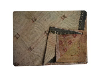 May include: A beige kantha quilt with a diamond pattern and red stitching. The quilt is folded in half, revealing a brown and yellow kantha quilt with a floral pattern.
