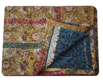May include: A kantha quilt with a patchwork design featuring floral patterns in shades of yellow, pink, and blue. The quilt is made of cotton and is hand-stitched.
