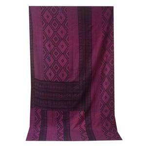 May include: A deep purple woven fabric with a black geometric pattern. The fabric has a textured surface and a slightly faded appearance.