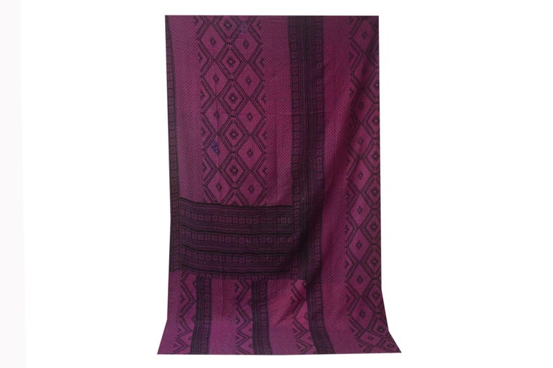 May include: A deep purple woven fabric with a black geometric pattern. The fabric has a textured surface and a slightly faded appearance.