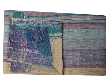 May include: A multi-colored kantha quilt with a patchwork design. The quilt is made of various shades of blue, purple, pink, and yellow. The quilt is folded in half and the edges are visible.