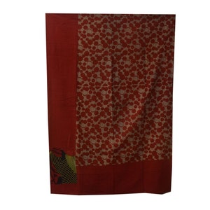 May include: A red and white patterned throw blanket with a green and black border. The blanket is made of cotton and is ideal for adding a touch of colour to any room.