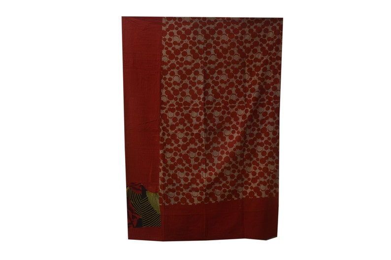 May include: A red and white patterned throw blanket with a green and black border. The blanket is made of cotton and is ideal for adding a touch of colour to any room.