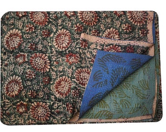 May include: A kantha quilt with a floral pattern in shades of brown, green, and white. The quilt is folded in half, revealing a blue and green kantha pattern on the reverse side.