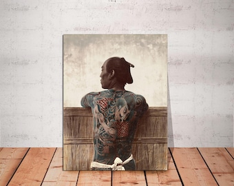May include: A man with a shaved head and a traditional Japanese tattoo on his back, looking out over a wooden railing. The tattoo is a detailed design of a dragon and other mythical creatures.