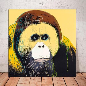 May include: A close-up portrait of an orangutan with a yellow, brown, black, and green color scheme. The orangutan's face is highlighted in yellow, with brown fur around its head and black fur around its face. The background is a pale yellow.