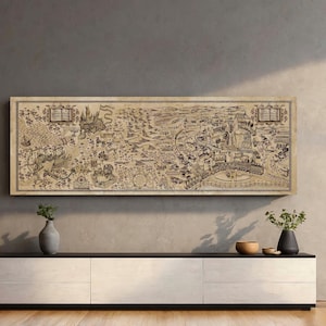 May include: A framed, sepia-toned map print with intricate details, depicting a fantasy landscape with castles, buildings, and text. The rectangular artwork is mounted on a wall above a modern, white and black cabinet. The print is a decorative piece.