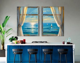 May include: Two framed canvas paintings depict ocean views through windows with sheer curtains. The artwork features a blue ocean, sailboats, and a sunset. The paintings are displayed above a blue kitchen island with black bar stools.