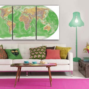 May include: A green world map print in a white frame hangs above a white couch with colorful throw pillows. A green lamp with a white light bulb is in the corner of the room.