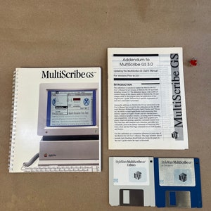 May include: A set of two floppy disks labeled "StyleWare MultiScribe GS" for use with the Apple GS computer. The disks are white and blue. The image also includes a manual for the MultiScribe GS software, and an addendum for updating the software to version 3.0.