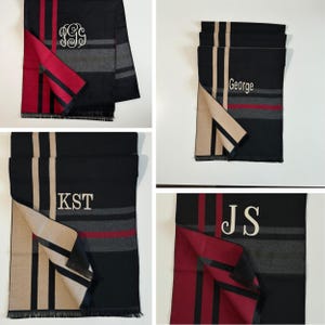 May include: A collection of rectangular scarves featuring a black, grey, and red striped pattern with fringe edges. Each scarf is personalised with embroidered text including the monograms PGG, KST, JS, and the name George in white thread.