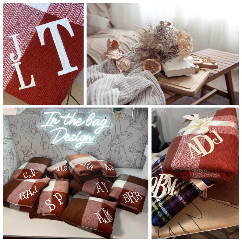May include: A collection of personalized red and white plaid blankets with various embroidered initials. The blankets are folded and stacked on a table with a neon sign that reads "In the bag Design".