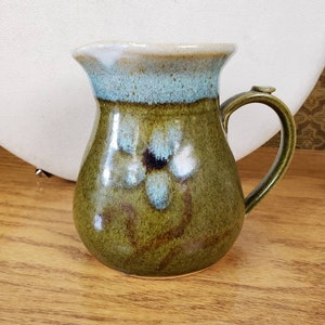 Pottery pitcher Green blue flower with cream ice lip speckled glaze