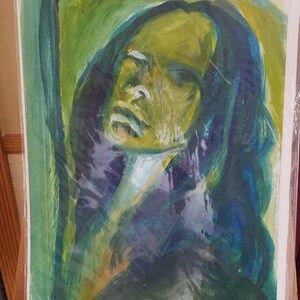 May include: Abstract painting of a person's face with green, blue, and yellow paint. The person's face is partially obscured by their hair.