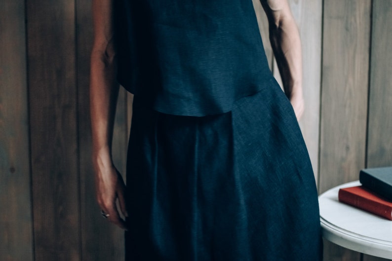 May include: A dark blue linen top and skirt set. The top is sleeveless and the skirt is long and flowing.