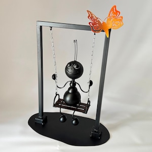 Whimsical Metal Ant on Swing: Garden Sculpture with Butterfly