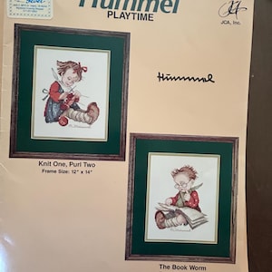 May include: A Hummel Playtime cross-stitch kit featuring two framed artworks. One depicts a child knitting, the other a child reading. Each frame is 12 x 14 inches. The kit includes the text "Knit One, Purl Two" and "The Book Worm".