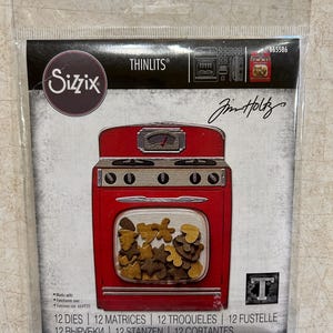 May include: A red Sizzix Thinlits die set featuring a retro oven design. The package includes 12 dies and the Jim Holtz signature. The oven's window displays various die-cut shapes. The package also includes the text "12 DIES | 12 MATRICES | 12 TROQUELES | 12 FUSTELLE".