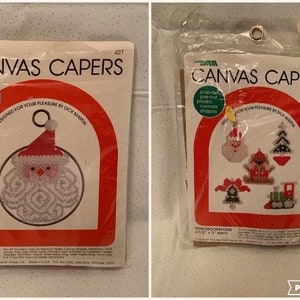 May include: Two packages of plastic canvas craft kits featuring Christmas designs. The first package contains a kit to make a 5-inch diameter shimmer ring Santa Claus ornament. The second package contains a kit to make five mini decorations: a snowman, a Christmas tree, a bell, a stocking, and a train. Both packages feature the text "Canvas Capers" and are designed by Dick Martin.